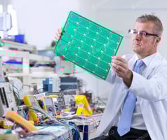 A Frontal View Of An Expert Engineer Properly Examining The Printed Circuit Board At An Electrical