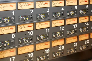 A bank of analog VU meters monitoring signal levels, illustrating the importance of tracking individual radio components for system reliability.
